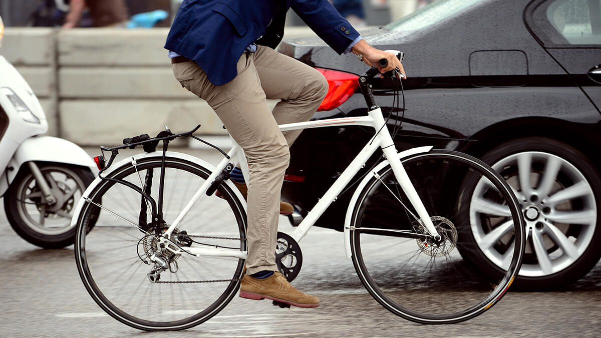 A bicyclist navigating through city traffic