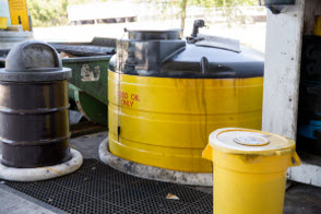 Motor oil disposal location with various sizes and shapes of oil drums