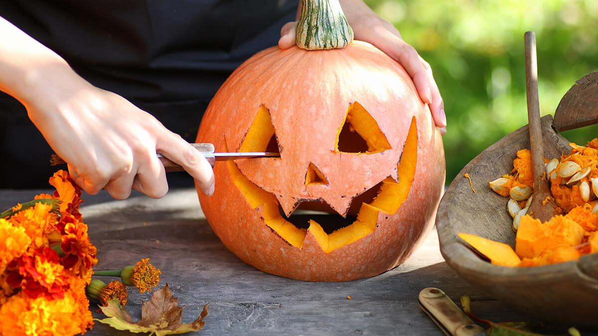 A person carving pumpkins