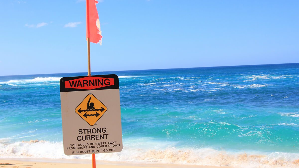 A red rip current warning flag on the beach