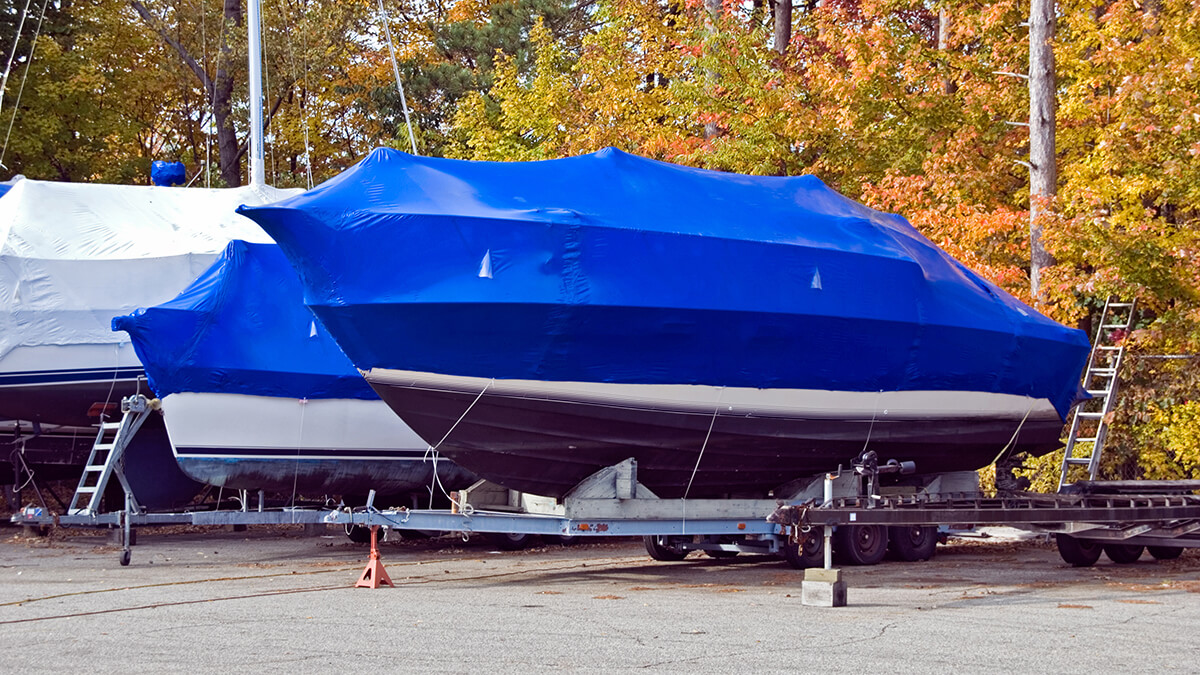 A row of boats covered with winterizing plastic