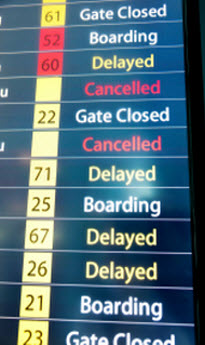 Multi-colored Airport Flight Board Showing Delays and Cancellations