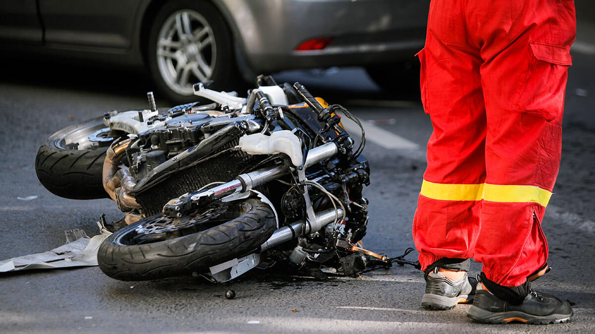 A crashed motorcycle laying on the road