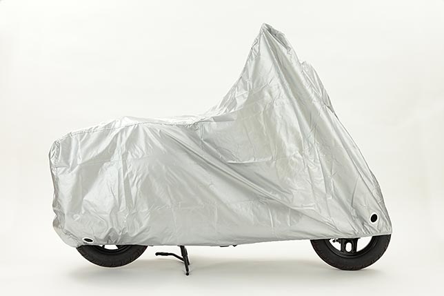 A motorcycle under cover and ready for winter break