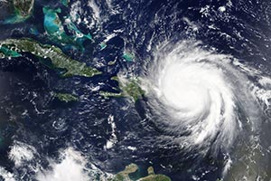Arial image of large hurricane over ocean approaching islands