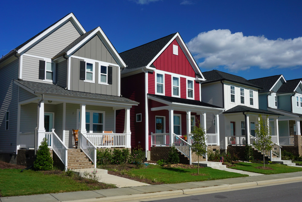 Front view of several different colored row homes
