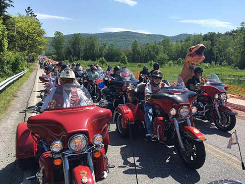 Hundreds of bikers riding side-by-side on the Adventurer Tour
