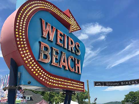 Weirs Beach lighted sign with an arrow pointing to the beach