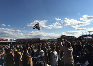 Crowd cheering motorcycle jumper