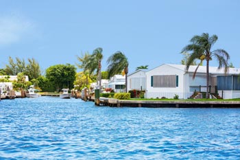 Homes on a lakefront surrounded by palm trees