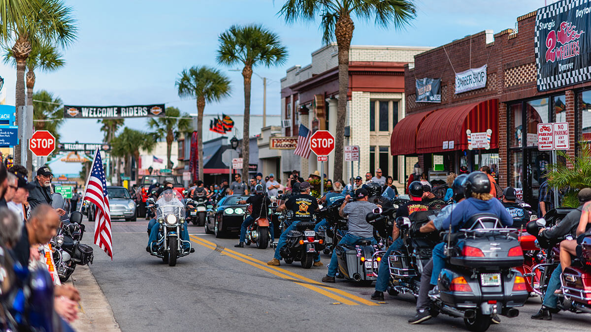 A parade of motorcycle riders on the town's main street