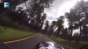 A first person view of motorcyclist riding on narrow highway