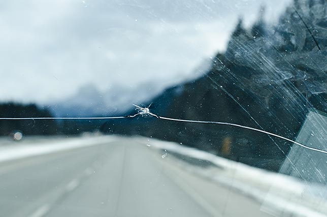 A close-up of a windshield crack across window