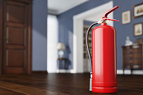 A red fire extinguisher sitting on the floor