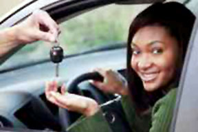 A happy teen receiving her car keys