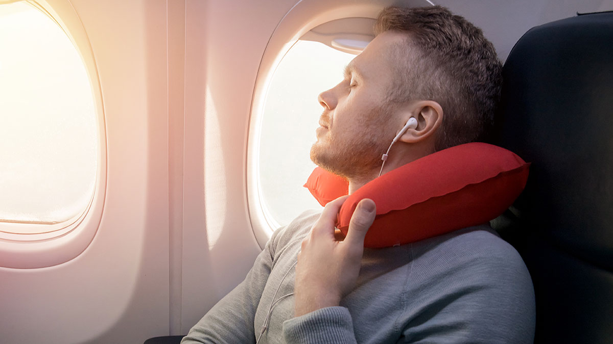 A person relaxing with music while in plane